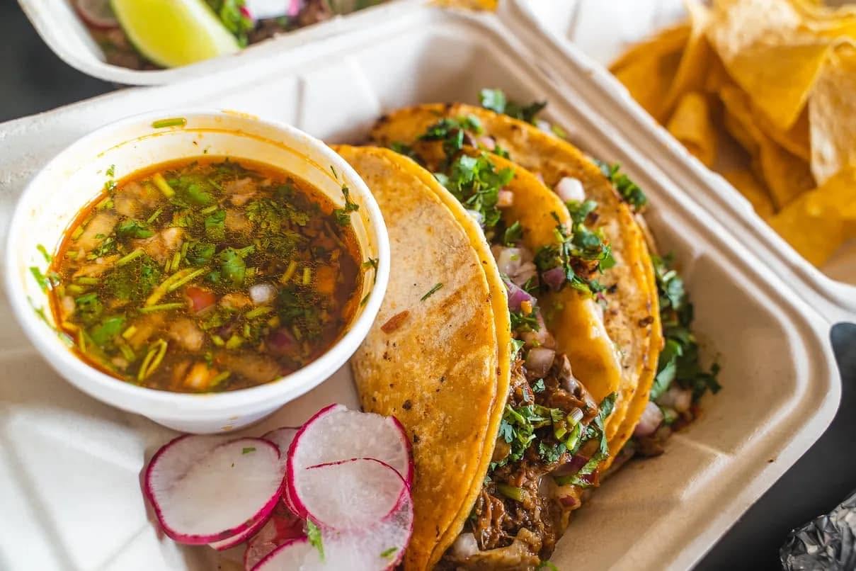 Kentacos birria tacos with broth, radishes and lime